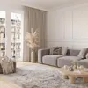 A modern living room with a light gray sofa, a round wooden coffee table, and a patterned rug. Anteprima dell’immagine prodotto