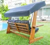 A wooden swing set with a canopy and cushions is placed on a grassy lawn next to a swimming pool. Podgląd zdjęcia produktu