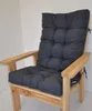 A dark gray cushion on a wooden chair against a white background. Produktbild-Vorschau
