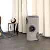 Two cats interacting with a cylindrical cat scratching tower in a room with curtains and a side table. Produktbild-Vorschau