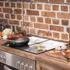 A kitchen counter with a stovetop, backsplash, and various cooking ingredients. Náhľad obrázku produktu