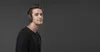A young man wearing headphones against a gray background. Produktbild-Vorschau