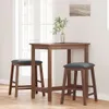 A wooden bar table with two bar stools in a room with a window. Anteprima dell’immagine prodotto