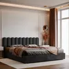 A bed with a dark upholstered headboard and bedding in a modern bedroom. Anteprima dell’immagine prodotto