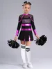 A young girl in a cheerleading costume holding pom-poms. Produktbild-Vorschau