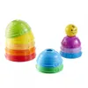 Three stacking toy sets are arranged on a white background. The largest set is on the left, with five colorful cups stacked. A smaller set of three cups is in the foreground, and a set of four cups topped with a yellow ball is on the right. Produktbild-Vorschau