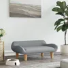 A pet bed is placed in a living room setting next to a plant and a piece of wall art. Podgląd zdjęcia produktu