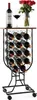 A wine rack filled with wine bottles, a glass of wine, and a bouquet of red roses on top. Náhľad obrázku produktu