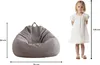 A child standing next to a beanbag chair, with dimensions indicated. Produktbild-Vorschau