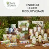 A collection of gardening products, including seed packets and planting bags, displayed on a wooden surface with plants in the background. Podgląd zdjęcia produktu