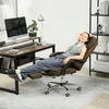 A woman is relaxing in a brown office chair with a footrest extended, in a home office setting. Voir les images du produit