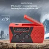 A red emergency radio with a solar panel on top, set against a background of a city skyline and stormy weather. Produktbild-Vorschau