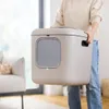 A person is holding a large beige cat litter box in a well-lit room. Anteprima dell’immagine prodotto