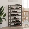 A wine rack filled with bottles of wine, placed against a wall with a plant to the side and a table and chairs in the background. Voir les images du produit