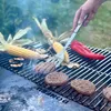 A person is grilling burgers, corn, and peppers on a BonFeu grill. Anteprima dell’immagine prodotto