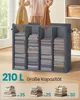 A person is folding clothes and placing them into a multi-compartment storage organizer. The organizer is filled with neatly folded linens. Text overlays indicate capacity and quantity. Produktbild-Vorschau
