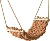 A close-up studio shot of a brown braided hammock swing with wooden supports and rope hangers, isolated on a white background. Podgląd zdjęcia produktu