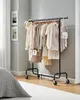 A clothing rack filled with pastel-colored women's clothing stands in a well-lit room. Produktbild-Vorschau