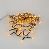 A string of yellow LED lights on a white and gray background. Podgląd zdjęcia produktu