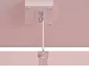 A close-up view of a ceiling mounting bracket with a cable attached, extending downwards. Náhled obrázku produktu
