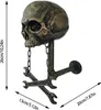 A skull-shaped wall mount with wrench accents, featuring measurement indicators. Produktbild-Vorschau
