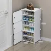 A white modular shoe rack with several pairs of shoes on display, placed in a corner next to a white door. A brown handbag is on top of the shoe rack. Náhľad obrázku produktu