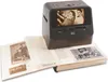 A digital scanner is placed on an open photo album, scanning a photograph. Produktbild-Vorschau