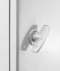 A close-up of a white electrical enclosure lock mechanism. Náhled obrázku produktu