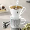 A coffee pour-over set with water being poured into the filter. Produktbild-Vorschau
