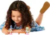 A young girl is playing with toys on the floor. Náhled obrázku produktu