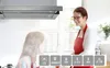 A mother and daughter in a kitchen, with a range hood above them. Voir les images du produit