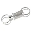 A product shot of a silver keychain coupling on a reflective white surface. Produktbild-Vorschau