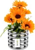 A bouquet of artificial sunflowers in a silver ribbed vase, with a product tag attached. Produktbild-Vorschau