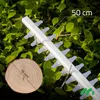 A close-up of a hedge trimmer blade with a wood slice showing its diameter, set against a background of green foliage. Náhľad obrázku produktu