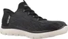 A side view of a black and gray Skechers slip-on shoe with a white sole. Náhled obrázku produktu