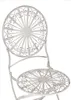 A close-up view of a white metal bistro chair with intricate scrollwork on the seat and backrest. Produktbild-Vorschau