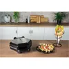 A kitchen counter scene with a waffle maker, a plate of food, and a bubble waffle cone. Produktbild-Vorschau