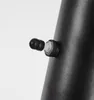 A close-up of a black lamp with a small black knob and a clear plastic component attached to it. Produktbild-Vorschau