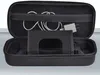 An open black carrying case for a gaming device, showing the interior with a charging cable and adapter stored in a mesh pocket. Anteprima dell’immagine prodotto