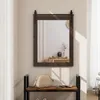 A mirror with a dark brown frame and a sliding mechanism is mounted on a wall above a wooden bench with a beige handbag on it. Podgląd zdjęcia produktu