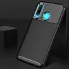 A black carbon fiber textured phone case with a camera module and fingerprint sensor is shown leaning against a dark surface. Podgląd zdjęcia produktu