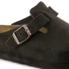 A close-up view of a brown Birkenstock sandal, focusing on the buckle and strap. Produktbild-Vorschau
