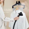 A person is using a garment steamer on a white shirt hanging on a hanger. Produktbild-Vorschau