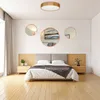 A bedroom scene with a bed, nightstands, and decorative mirrors on the wall. Produktbild-Vorschau