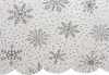 A close-up view of a white tablecloth with a silver snowflake pattern. Náhľad obrázku produktu