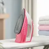 A pink and white steam iron rests on an ironing board, with a stack of folded laundry in the background. Náhľad obrázku produktu