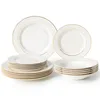 A set of white porcelain plates and bowls with gold trim, arranged on a white background. Produktbild-Vorschau