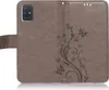 A brown flip case for a Samsung Galaxy A51 phone, with a floral and butterfly embossed pattern. Produktbild-Vorschau