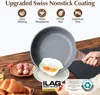 A hand is holding a frying pan with a fried egg in it, over a plate. Croissants and other food items are visible on a wooden table. Produktbild-Vorschau
