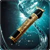 A close-up of a gold and black hair clipper with ornate detailing, surrounded by swirling water and bubbles. Náhled obrázku produktu